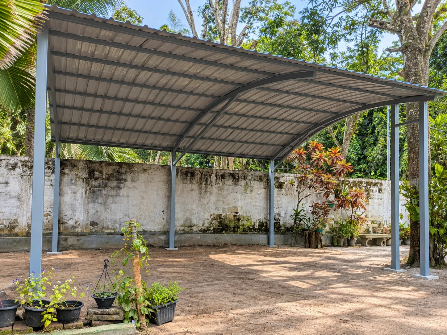 Curved carport over a garden courtyard