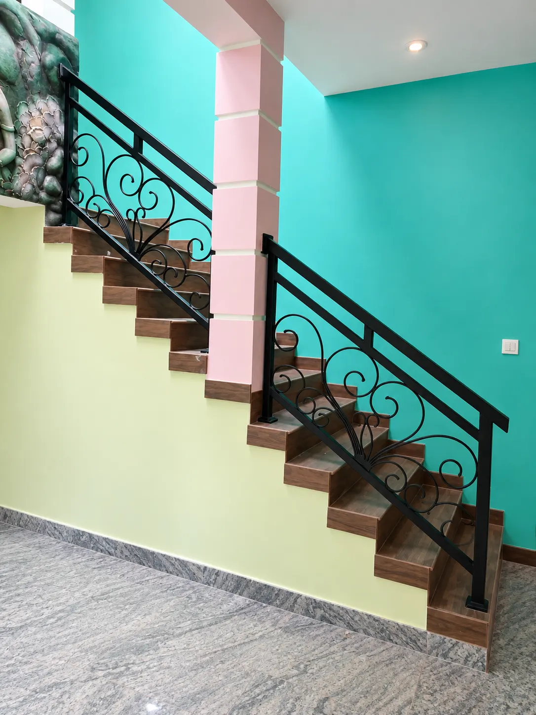 Decorative scrollwork staircase railing with wood treads