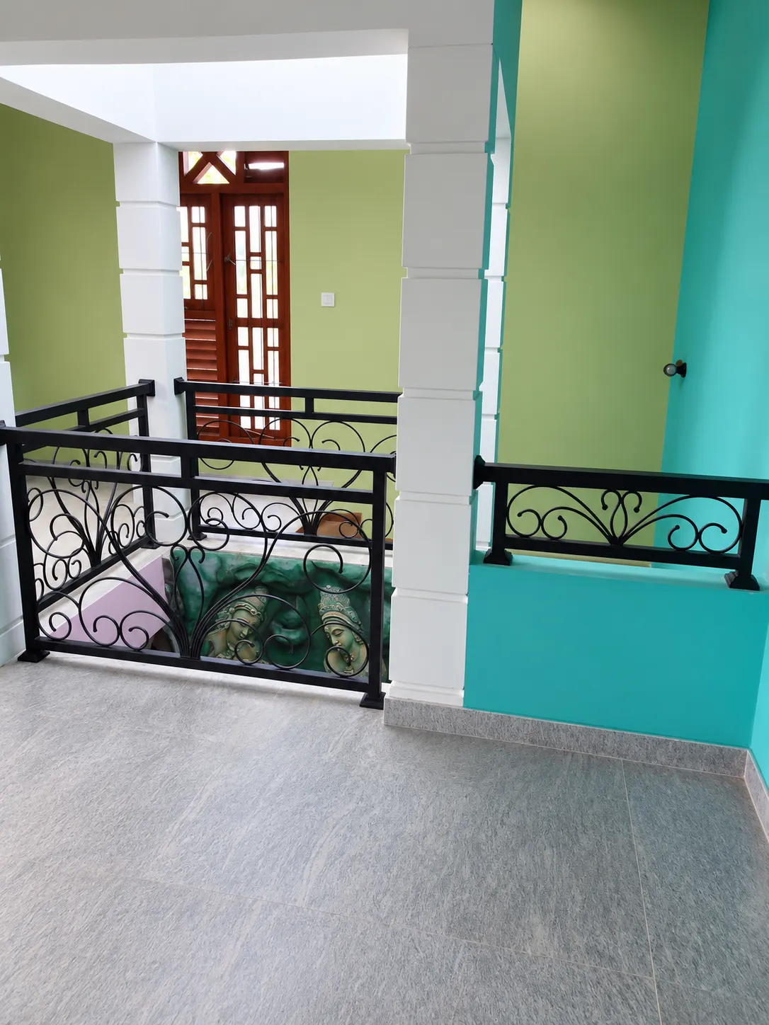Scroll balustrade with stone relief panel below